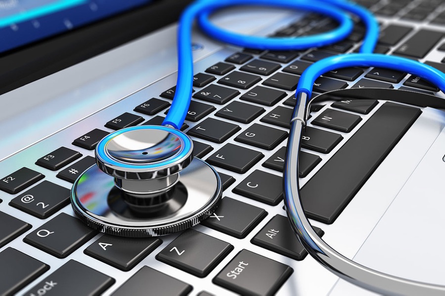 Laptop keyboard with a stethoscope, representing computer diagnostics