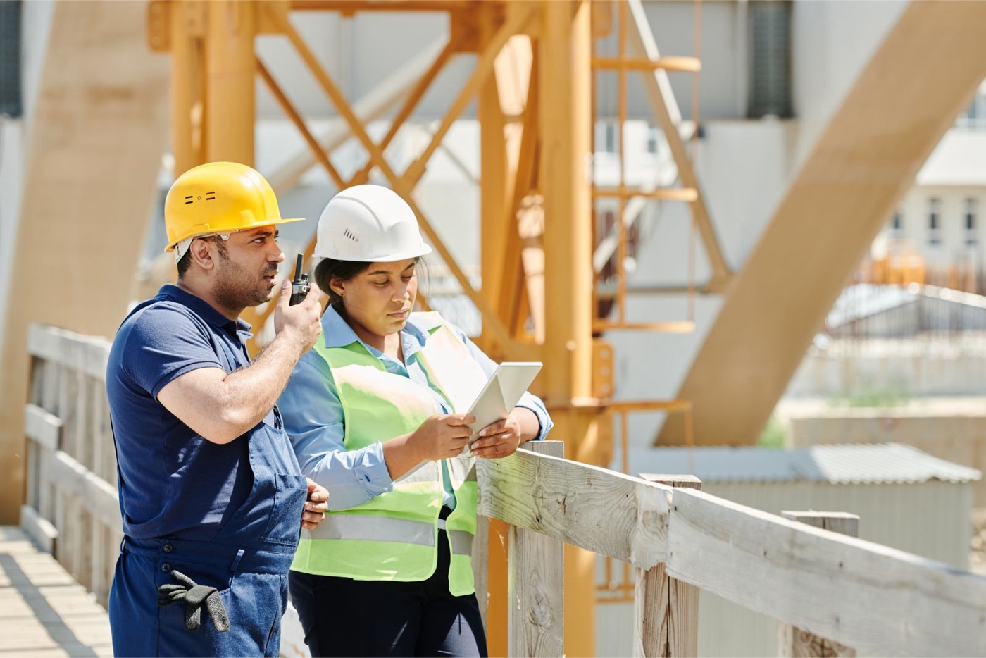 Engineers assessing a construction site with a tablet